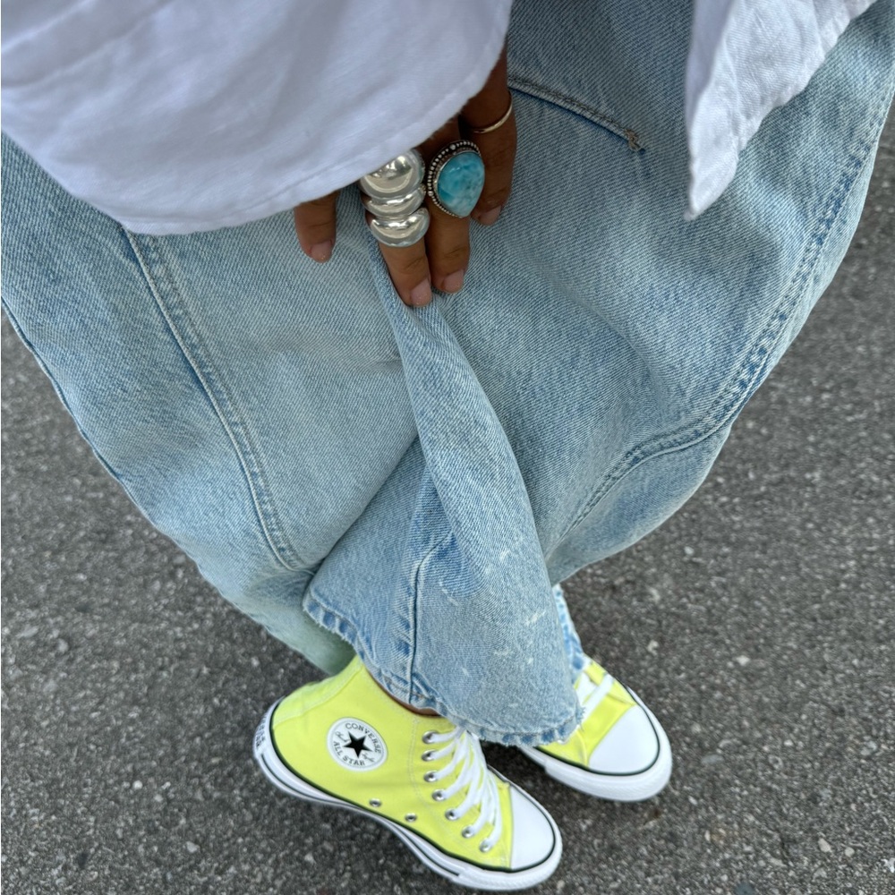 Yellow high top converse.